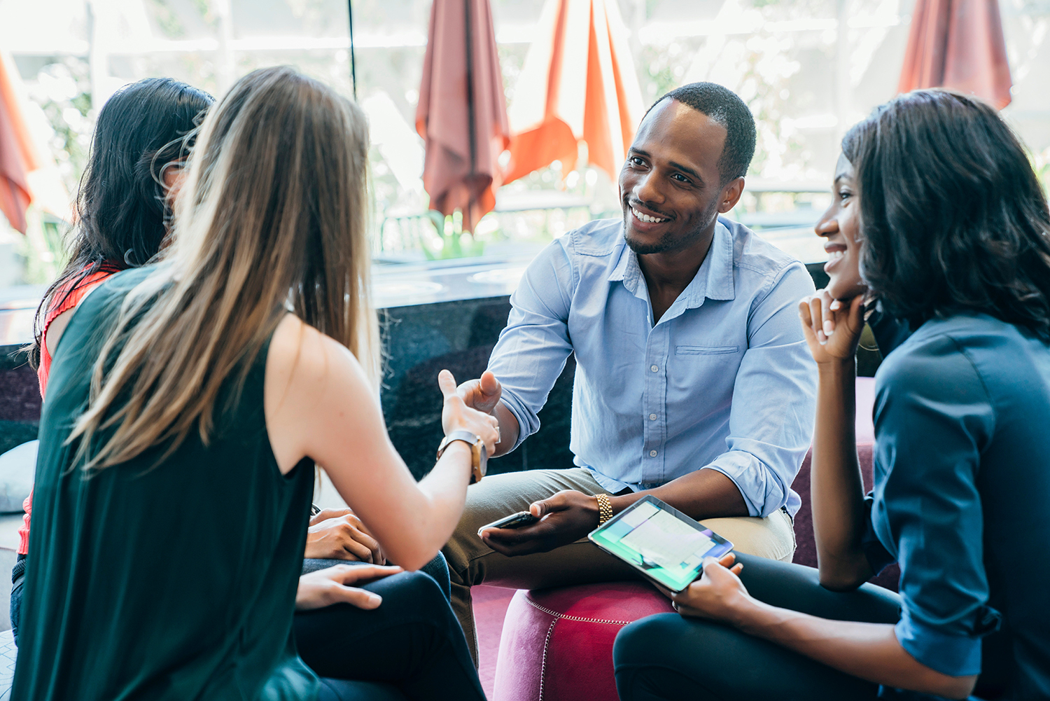 Business meeting in lobby of colorful modern office space